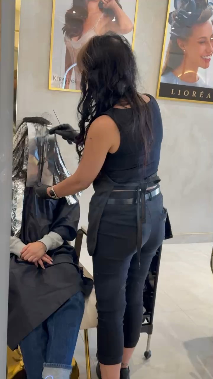 Colourist applying balayage highlights with foils to a client's hair at Lioréa Lounge in Brampton