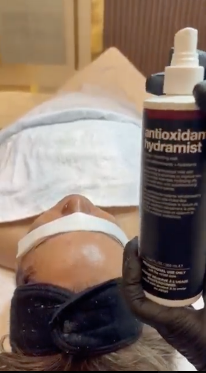 esthetician performing a professional skin analysis at Lioréa Lounge