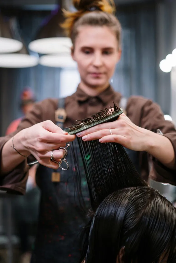 stylist cutting and styling hair at Lioréa Lounge hair salon in Brampton