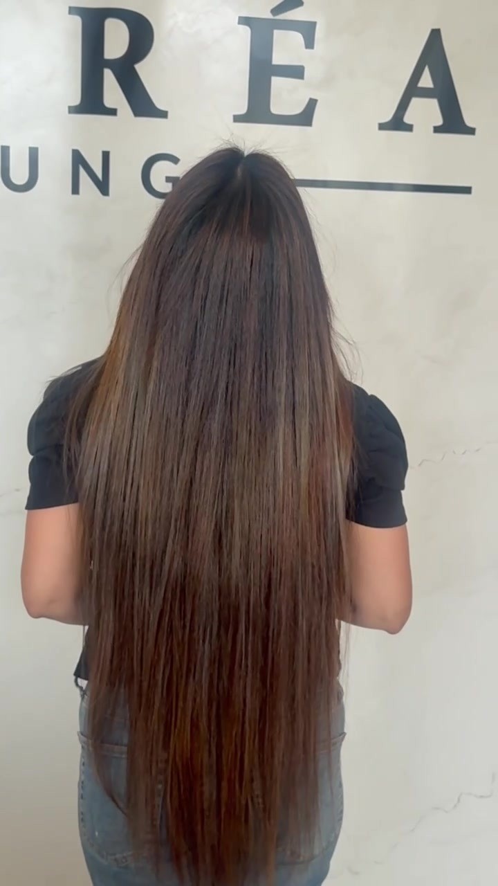 Long, glossy, straight hair result after keratin smoothing treatment at Lioréa Lounge
